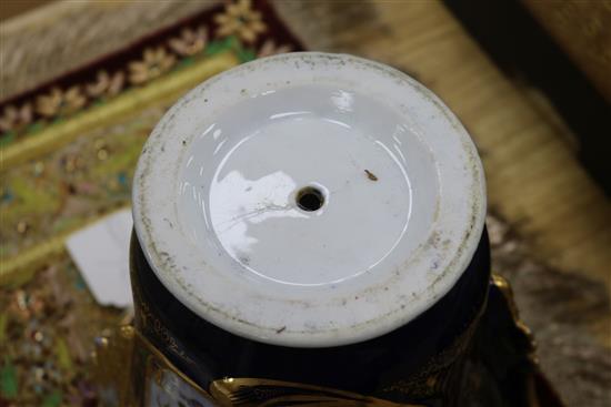 A late 19th century French porcelain two handled vase, on cast gilt metal base